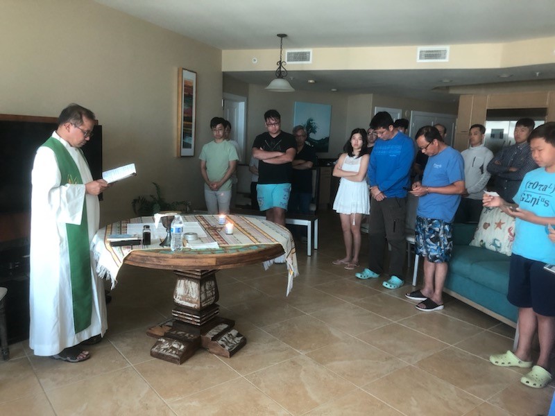 Catholic priest celebrating Mass in a home