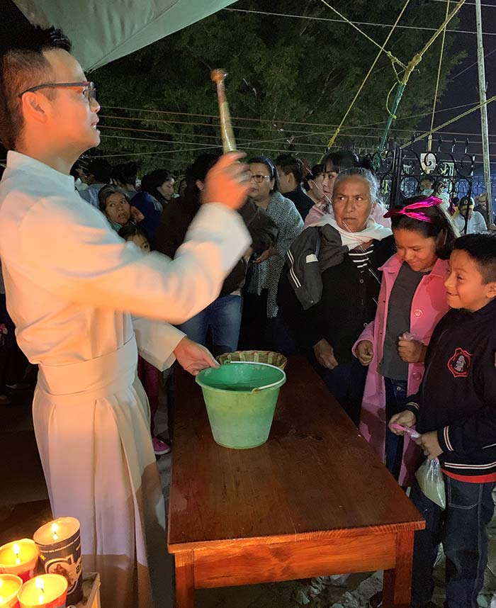 Derek Nguyen performs a religious ceremony outdoors