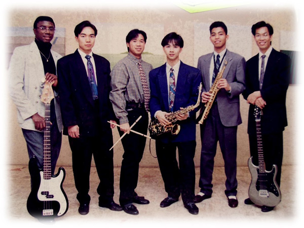 Group of musicians posing for a photo with instruments