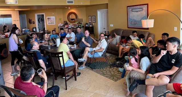 A group of people gathered around a table having a discussion